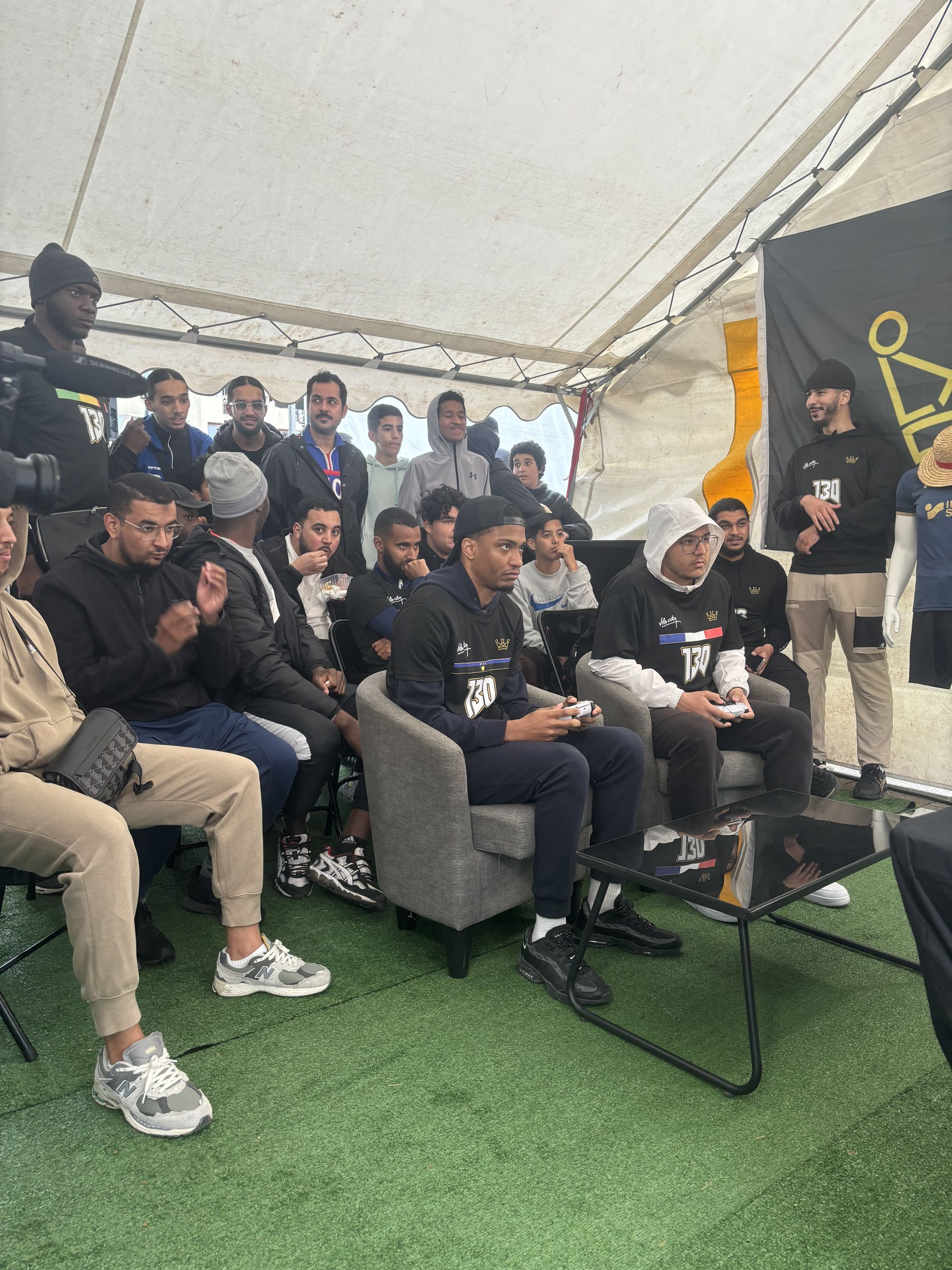 Participants réunis autour des consoles sous le stand